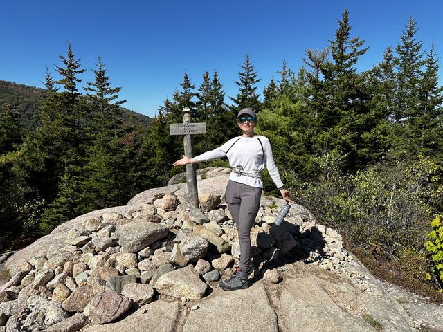 Anfisa hiking at a mountain summit